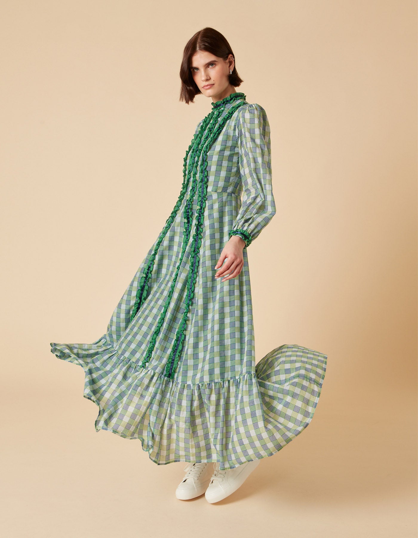With a frill detail running through the top to bottom of dress and on the cuff, this blue green geo print covers this dress’s lustrous silk voile fabric. 
